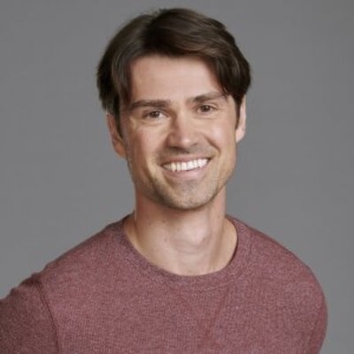 Picture of Corey Sevier posing for a photoshoot wearing red color t shirt